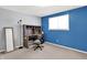 Bedroom featuring an office nook with desk, chair, standing mirror, and bright blue accent wall at 5614 Personality Ct, Indianapolis, IN 46237