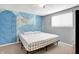 Bright bedroom features a queen size bed, a leafy feature wall, and a large window at 5614 Personality Ct, Indianapolis, IN 46237
