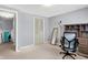 Bedroom view showcasing the desk, chair, and mirror, along with closet and hall access at 5614 Personality Ct, Indianapolis, IN 46237