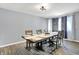 Bright dining room features wood flooring, modern lighting, and a large table for entertaining at 5614 Personality Ct, Indianapolis, IN 46237
