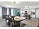 Open-concept dining room features modern lighting, neutral paint colors, and wood flooring at 5614 Personality Ct, Indianapolis, IN 46237
