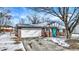 Charming brick home with a two-car garage and an eye-catching teal front door at 5614 Personality Ct, Indianapolis, IN 46237