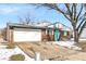 Charming brick home features an attached garage, and a pop of color with the bright blue front door at 5614 Personality Ct, Indianapolis, IN 46237