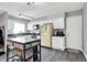 Well-lit kitchen featuring white cabinetry, stainless steel appliances, a functional kitchen island, and modern countertops at 5614 Personality Ct, Indianapolis, IN 46237