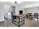 Open-concept living and dining space features an island, stairs to the basement, and wood floors at 5614 Personality Ct, Indianapolis, IN 46237