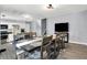 Open-concept living and dining space features a large table, tv, and stairs to the basement at 5614 Personality Ct, Indianapolis, IN 46237