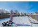 Large fenced backyard with play equipment visible beyond the deck and patio area at 5638 Congressional Pl, Indianapolis, IN 46235