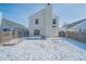 Back exterior view of home and deck with snow-covered backyard and a wood privacy fence at 5638 Congressional Pl, Indianapolis, IN 46235
