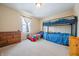 Cozy ' bedroom with bunk beds, dresser, and a large window at 5638 Congressional Pl, Indianapolis, IN 46235