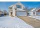 Charming two-story home with a two-car garage and a snow-covered front yard and driveway at 5638 Congressional Pl, Indianapolis, IN 46235