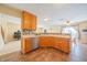Bright kitchen with wood cabinets, stainless steel appliances, and a view into an adjacent living area at 5638 Congressional Pl, Indianapolis, IN 46235