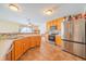 Bright kitchen with wooden cabinets, stainless steel appliances, and tile flooring at 5638 Congressional Pl, Indianapolis, IN 46235