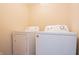 Laundry room with white washer and dryer set and a wall outlet at 5638 Congressional Pl, Indianapolis, IN 46235