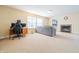 Bright living room with fireplace, neutral carpet, and comfortable gray sofa at 5638 Congressional Pl, Indianapolis, IN 46235