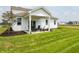 Backyard features a covered patio with outdoor seating and lush green lawn at 5879 Handbell Ln, Greenwood, IN 46143