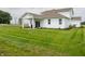 Spacious backyard with a well-maintained lawn, covered patio, and tasteful landscaping at 5879 Handbell Ln, Greenwood, IN 46143