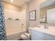 Bathroom featuring a shower-tub combination, white subway tile, and modern fixtures at 5879 Handbell Ln, Greenwood, IN 46143