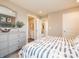 Comfortable bedroom boasts an ensuite bathroom, stylish dresser, and neutral decor at 5879 Handbell Ln, Greenwood, IN 46143