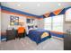 Fun bedroom features a space themed decor with blue and orange accents at 5879 Handbell Ln, Greenwood, IN 46143
