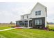 Attractive two-story model home with a modern design, showcasing a manicured lawn, and beautiful landscaping at 5879 Handbell Ln, Greenwood, IN 46143