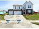 Two-story home featuring a brick and siding facade, two-car garage, and a well-manicured front lawn at 5879 Handbell Ln, Greenwood, IN 46143