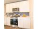 Modern kitchen featuring stainless steel appliances and sleek white cabinetry for a clean look at 5879 Handbell Ln, Greenwood, IN 46143