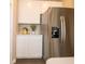 Bright kitchen showcases stainless steel refrigerator and white cabinetry with modern fixtures at 5879 Handbell Ln, Greenwood, IN 46143