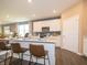 Bright kitchen showcases counter seating, quartz countertops, stainless appliances, and modern fixtures at 5879 Handbell Ln, Greenwood, IN 46143