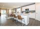 Open-concept kitchen featuring modern white cabinets, stainless steel appliances, and a spacious island with bar seating at 5879 Handbell Ln, Greenwood, IN 46143