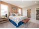 Well-lit main bedroom boasts two large windows, carpet floors, and neutral paint at 5879 Handbell Ln, Greenwood, IN 46143