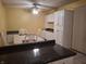 Bright dining area with a ceiling fan, white chairs, a dining table, and adjacent kitchen cabinets at 6029 Old Mill Dr, Indianapolis, IN 46221