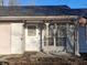 A charming front porch with decorative hanging ornaments and a white trimmed entry door at 6029 Old Mill Dr, Indianapolis, IN 46221