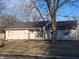 Charming single-story home with an attached garage, light siding and a cozy front yard at 6029 Old Mill Dr, Indianapolis, IN 46221