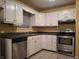 Bright kitchen featuring stainless steel appliances, ample cabinet space, and tile flooring at 6029 Old Mill Dr, Indianapolis, IN 46221
