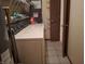 Functional laundry area with a washer, dryer, water heater and shelving space at 6029 Old Mill Dr, Indianapolis, IN 46221