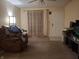 Spacious living room with neutral carpet, natural light, and a cozy feel at 6029 Old Mill Dr, Indianapolis, IN 46221