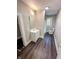 Updated bathroom featuring wood floors, vanity with storage, and combined shower and tub; recently remodeled at 638 W 30Th St, Indianapolis, IN 46208