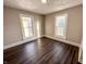 A bedroom featuring two windows providing natural light and brown wood flooring at 638 W 30Th St, Indianapolis, IN 46208