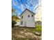 A view of the back exterior of the home with white siding and a grass backyard at 638 W 30Th St, Indianapolis, IN 46208