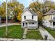 Exterior view of the house featuring a well-kept lawn, traditional architecture, and fall foliage at 638 W 30Th St, Indianapolis, IN 46208
