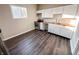 Sunlit kitchen with dark wood floors, white cabinets, stainless steel appliances, and butcher block countertops at 638 W 30Th St, Indianapolis, IN 46208