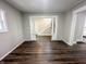 Living room with dark wood floors and open access to the staircase and other rooms, providing a bright and spacious feel at 638 W 30Th St, Indianapolis, IN 46208