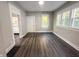 Bright living room featuring wood floors, fresh gray paint, and multiple windows that let in natural light at 638 W 30Th St, Indianapolis, IN 46208