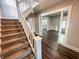 View of the staircase with carpet and white railings, leading to a large living space at 638 W 30Th St, Indianapolis, IN 46208