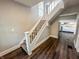 Staircase with modern flooring and white railings leading to the upper level of the home at 638 W 30Th St, Indianapolis, IN 46208