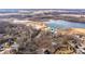 Drone shot of the property with a view of nearby lake and wooded residential area at 671 State Road 267, Mooresville, IN 46158
