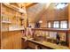 Wood-paneled bar features shelving with decor, sink, and a unique design, perfect for entertaining guests at 671 State Road 267, Mooresville, IN 46158