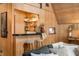 Charming wood-paneled bar area features stools, shelving with decor, and a cozy, inviting atmosphere at 671 State Road 267, Mooresville, IN 46158