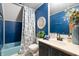 Bathroom with blue walls, tile flooring, and a shower and bathtub combo at 671 State Road 267, Mooresville, IN 46158