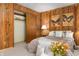Comfortable bedroom features wood paneling, soft lighting, and a closet for ample storage at 671 State Road 267, Mooresville, IN 46158